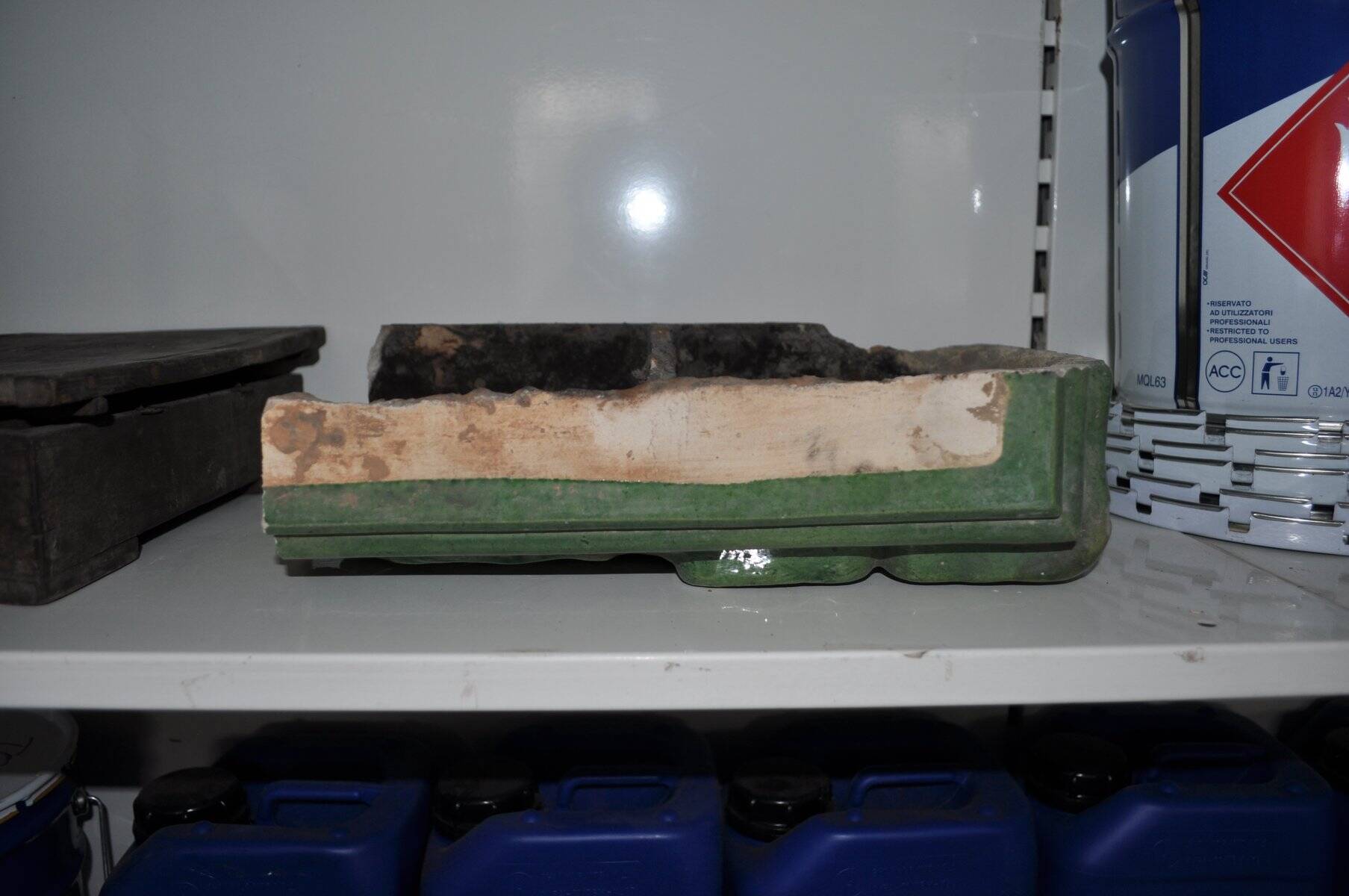 Green enamelled ceramic stove tile — finely sculpted Hungarian pattern from the late 19th century.