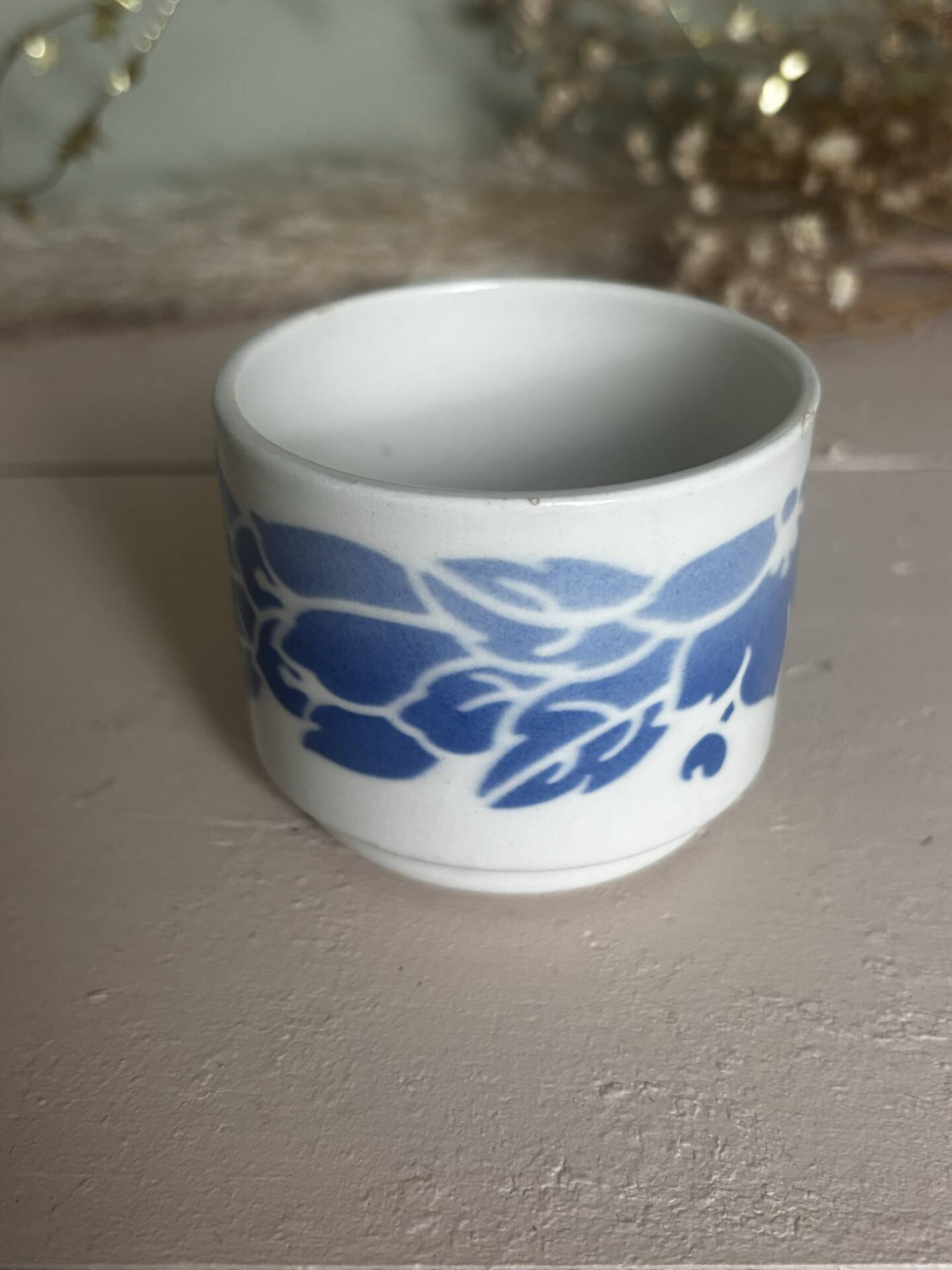 Set of 3 antique ceramic cups with blue floral pattern.