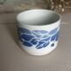 Set of 3 antique ceramic cups with blue floral pattern.
