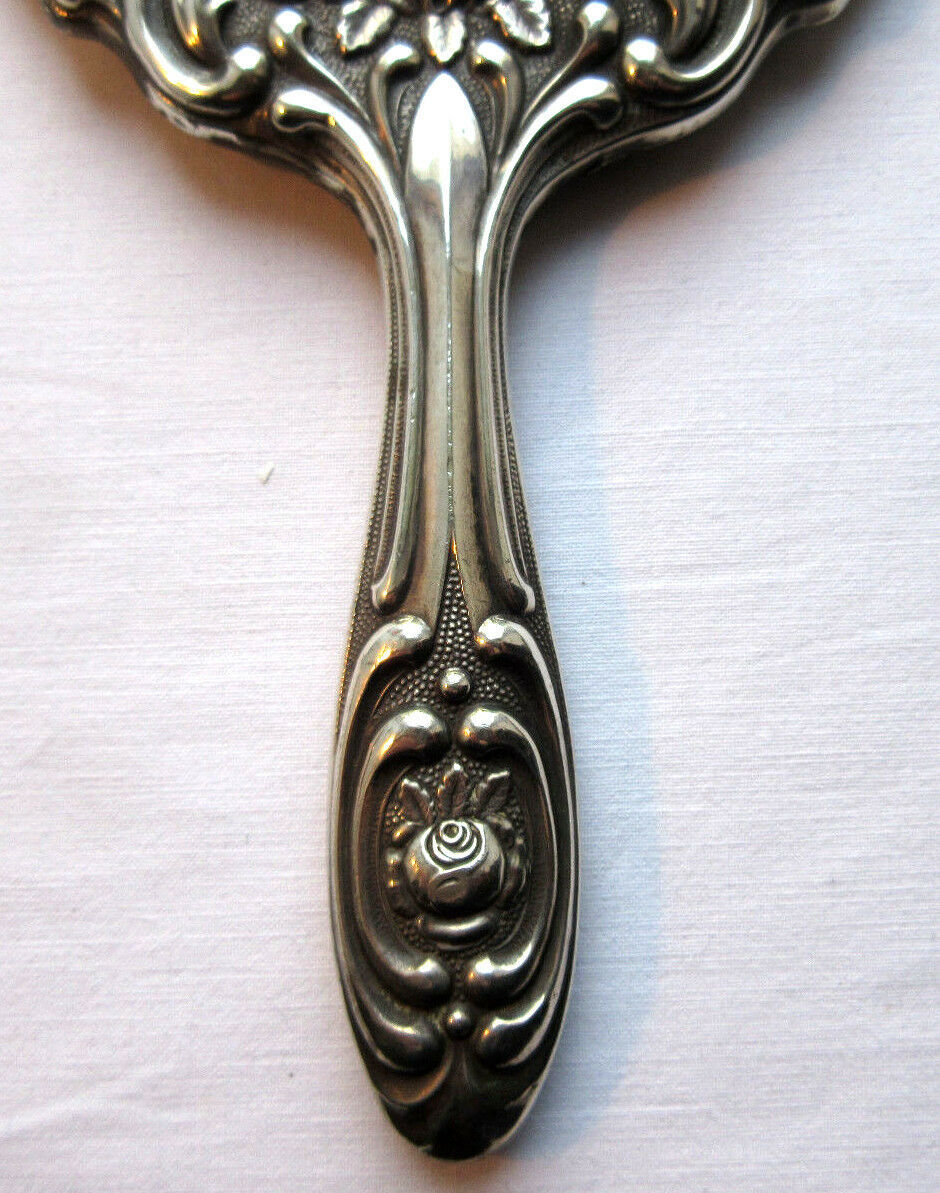Art Nouveau hand-facing, mirror in repulsed silver frame, rose decoration 14x27cm
