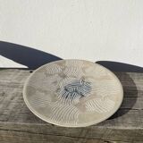 Round ethnic handmade fish dish