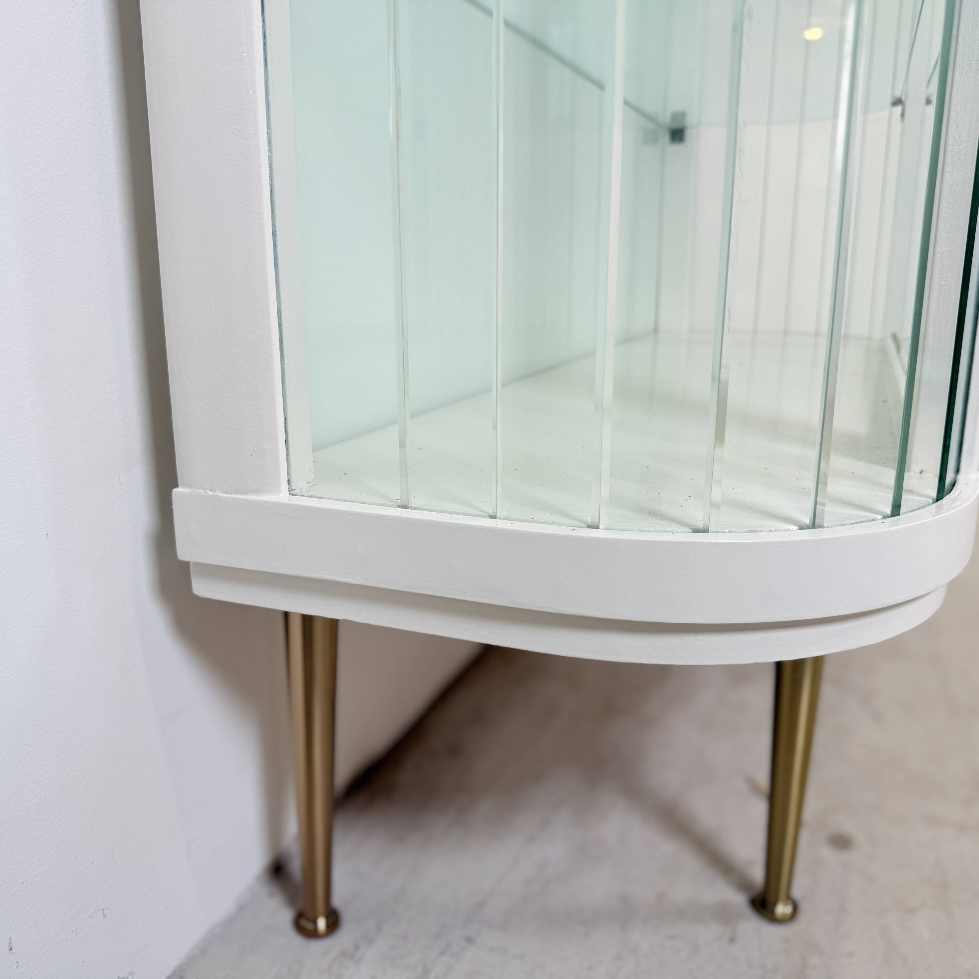 White vintage slatted display case on gold legs