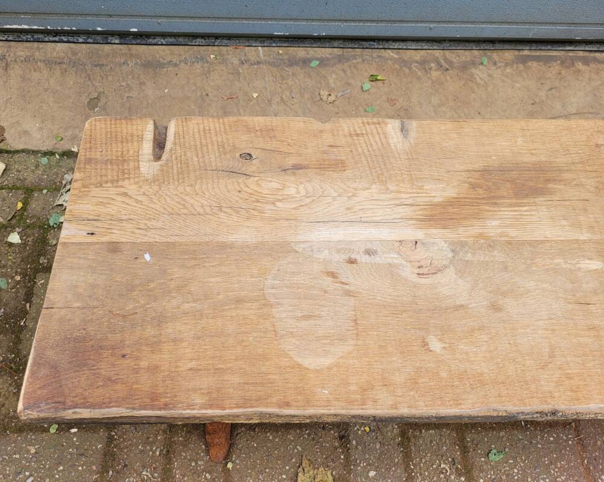 French country-style cast iron garden bench with old barn wood plank.