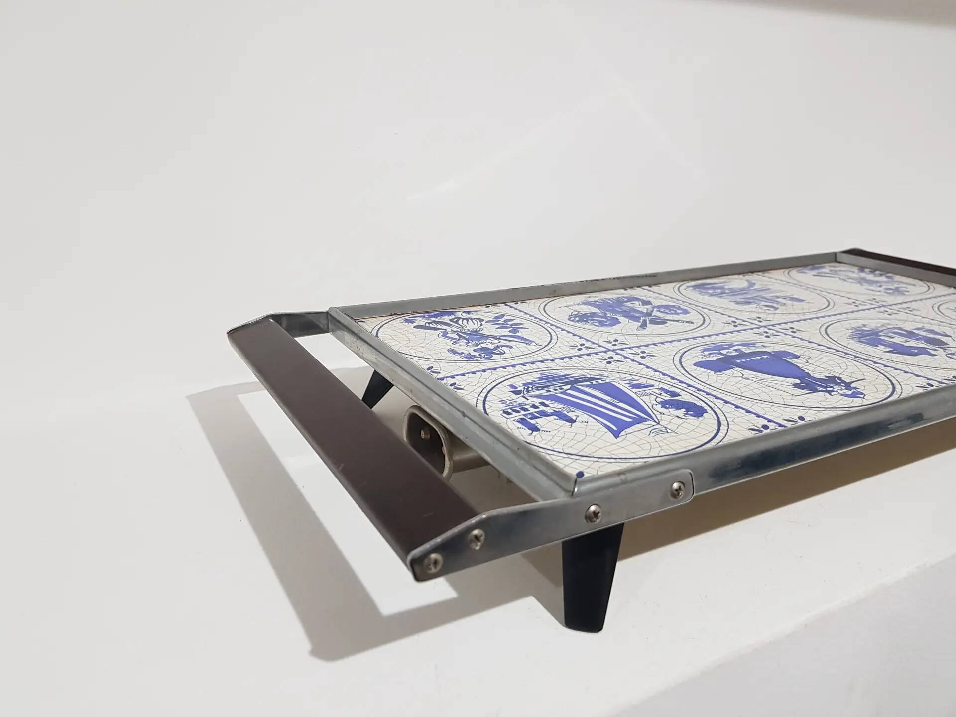 Heating plate, blue and white ceramic, brown rosewood, black metal, Germany, 1970s.