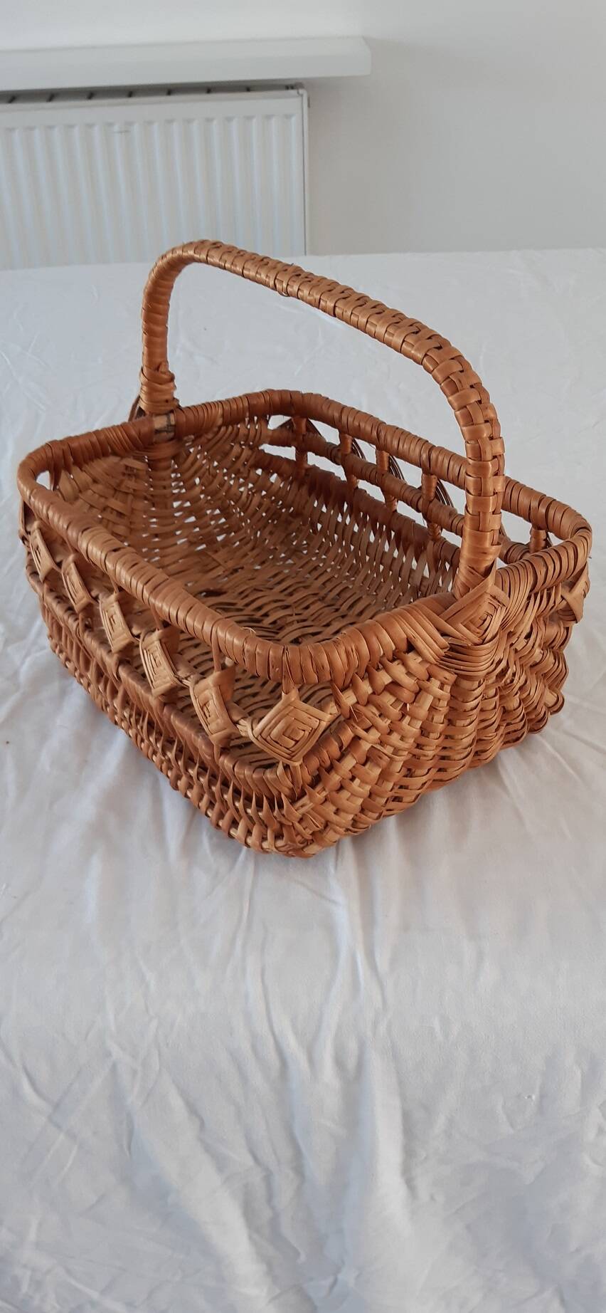 Old wicker basket with diamond-shaped decorations