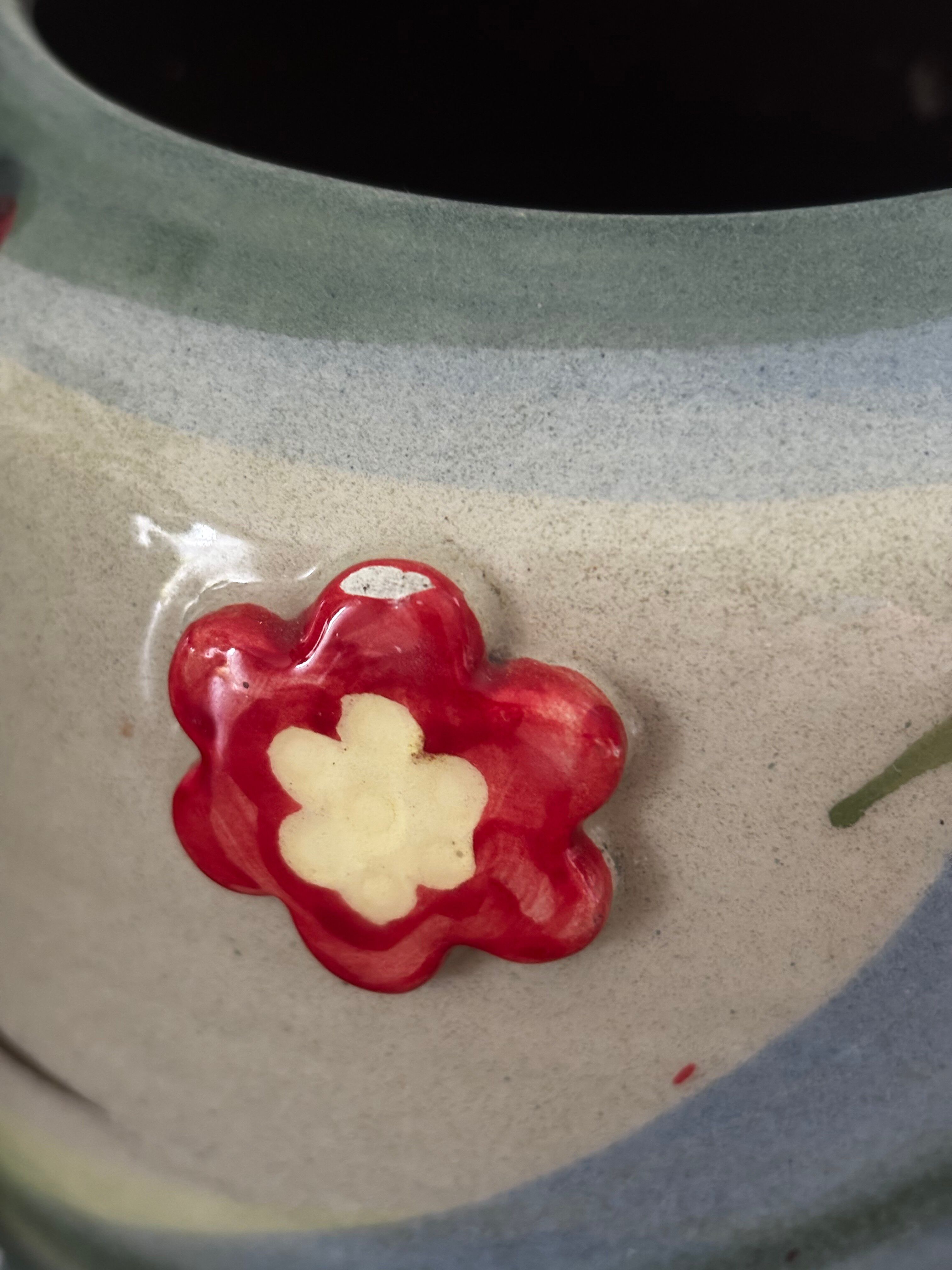 Superb handcrafted pottery pot with relief flowers signed on the back.