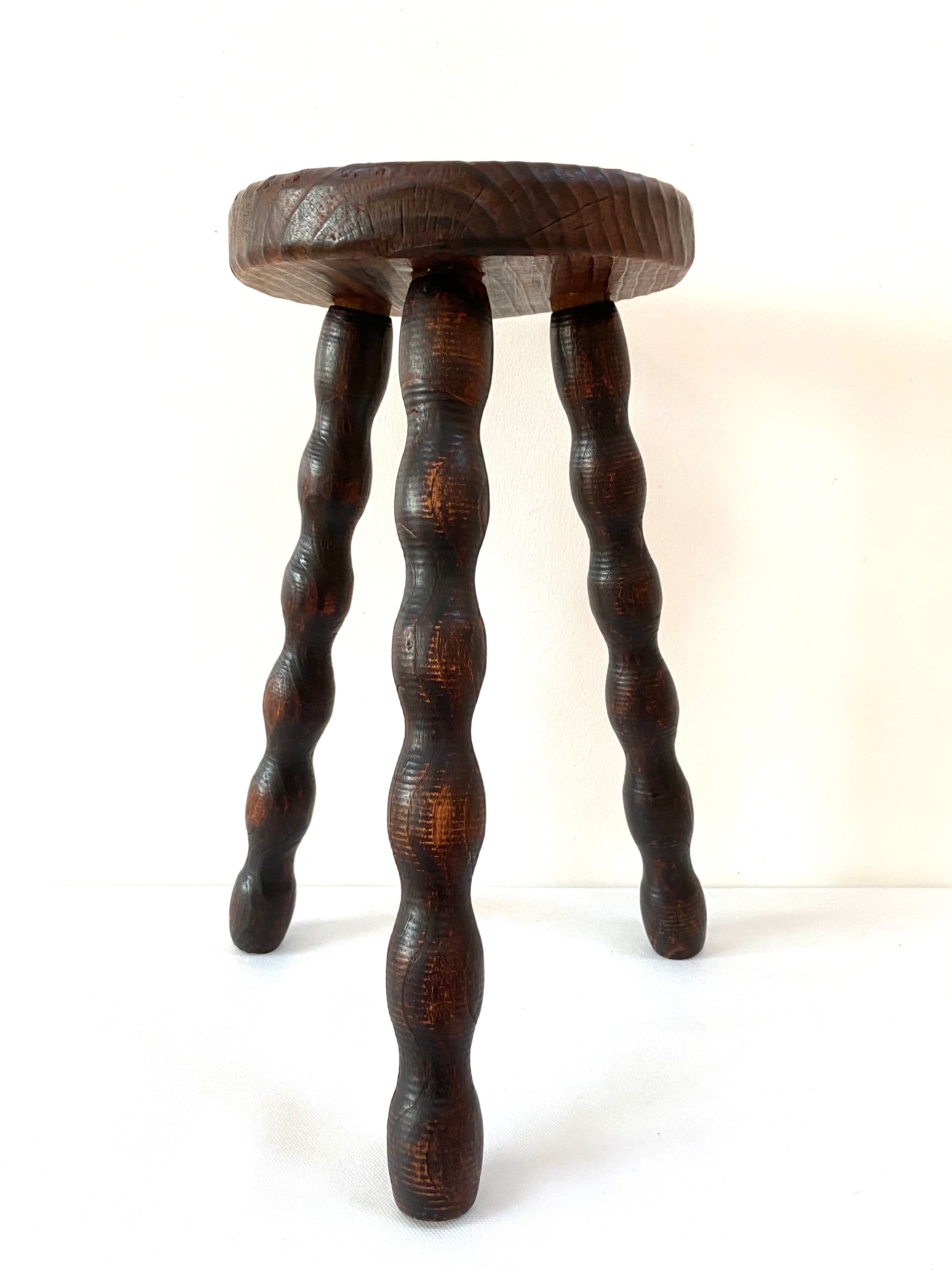 Old tripod stool in solid wood