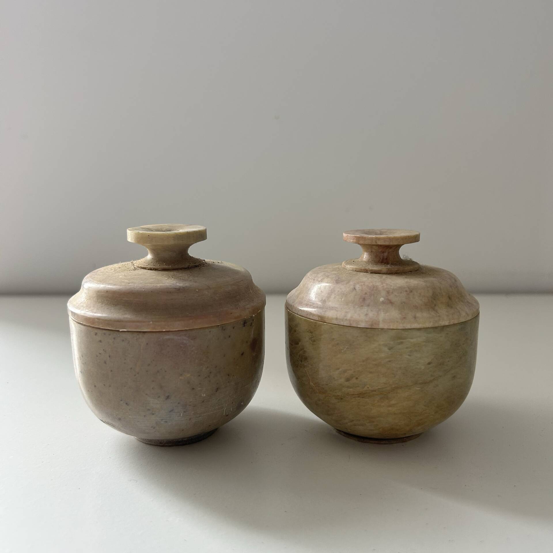2 small stone urns