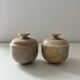 2 small stone urns