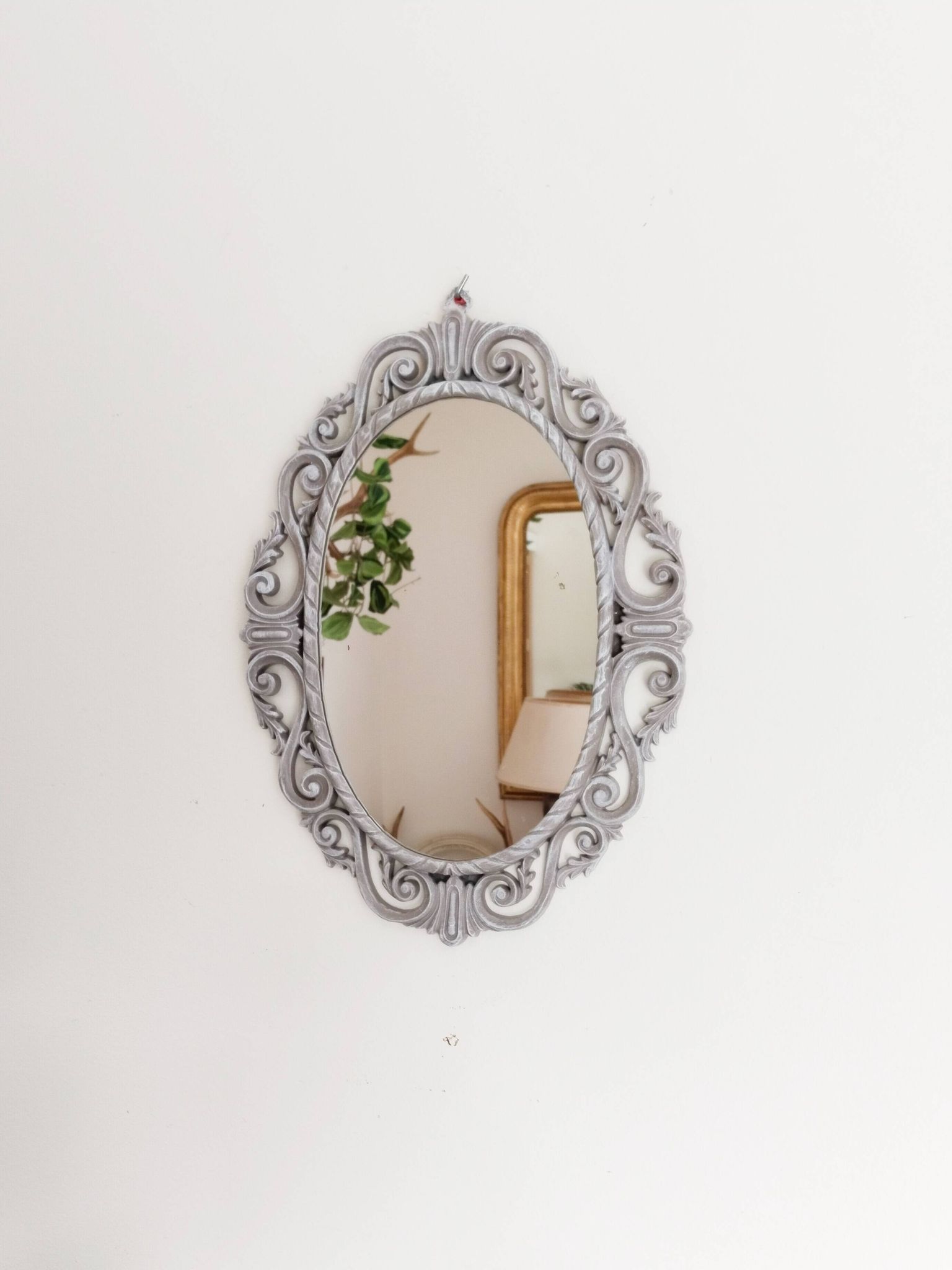 Louis XVI style patinated oval mirror