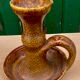 Candle holder in old earthenware signed by the 2 glued aa of the Accolay factory
