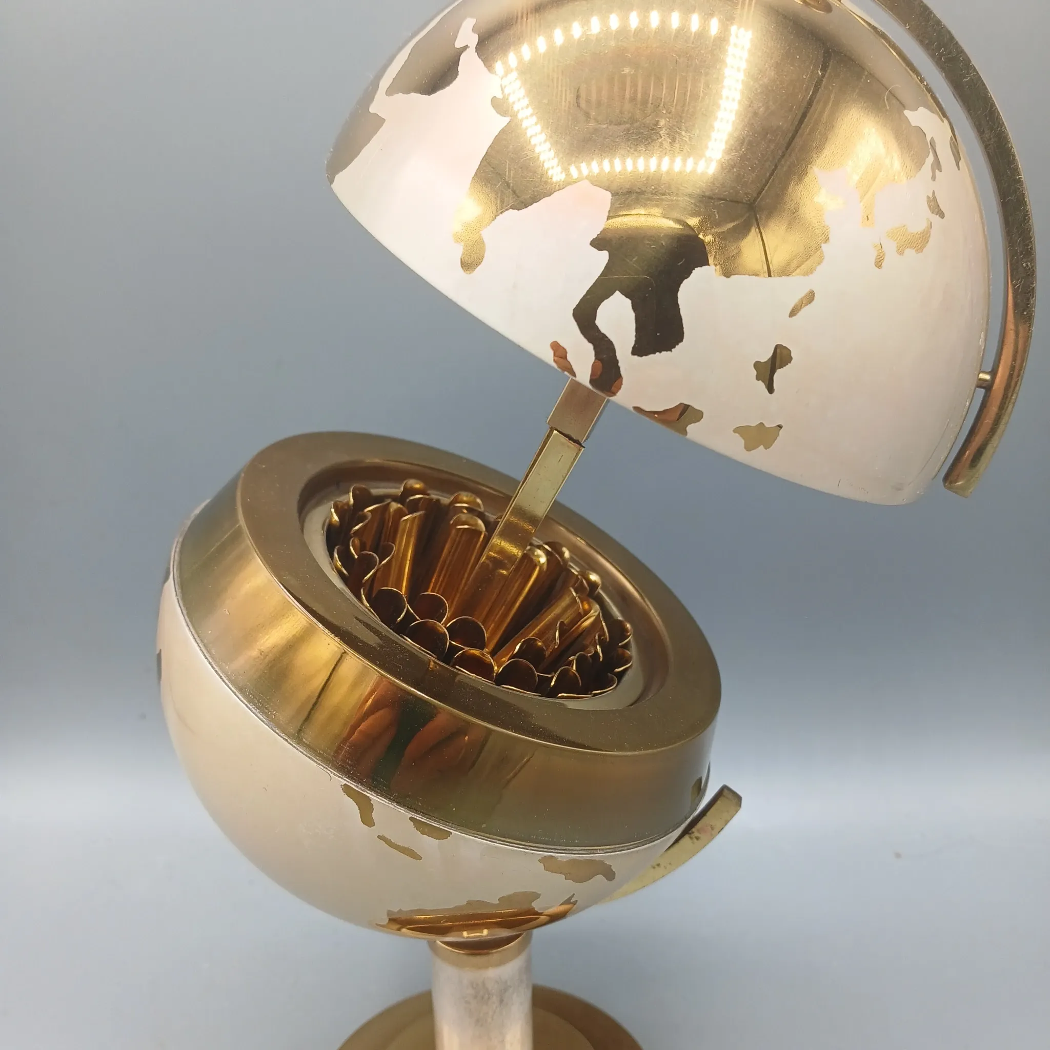 Vintage brass globe cigarette dispenser