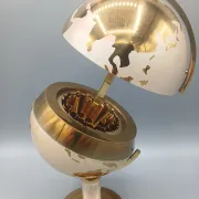 Vintage brass globe cigarette dispenser
