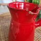 Ancient pitcher in red enamelled sandstone