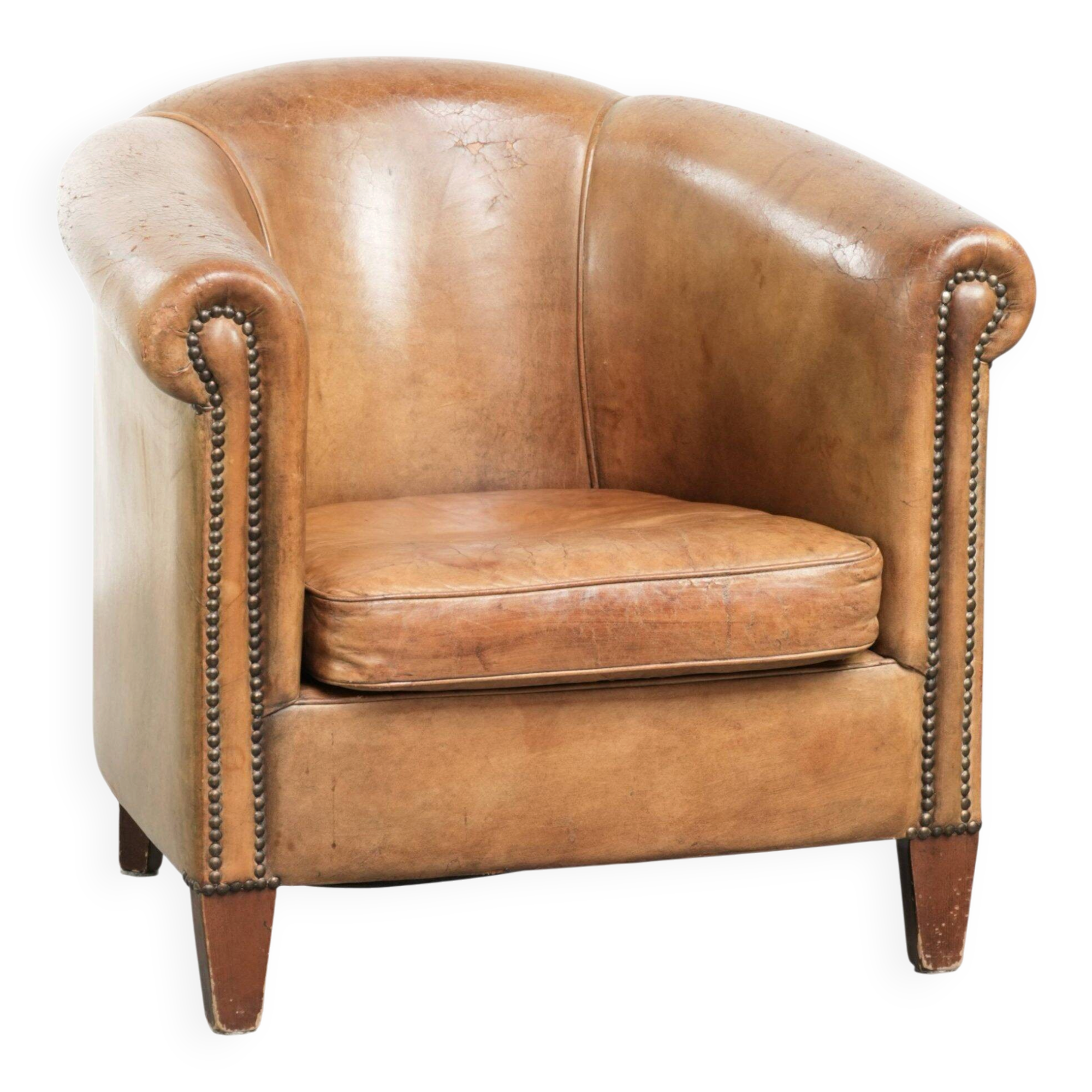 Vintage sheepskin club armchair finished with decorative nails