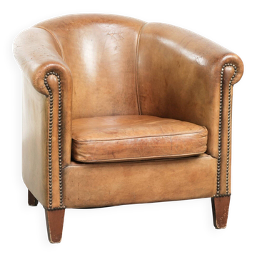 Vintage sheepskin club armchair finished with decorative nails