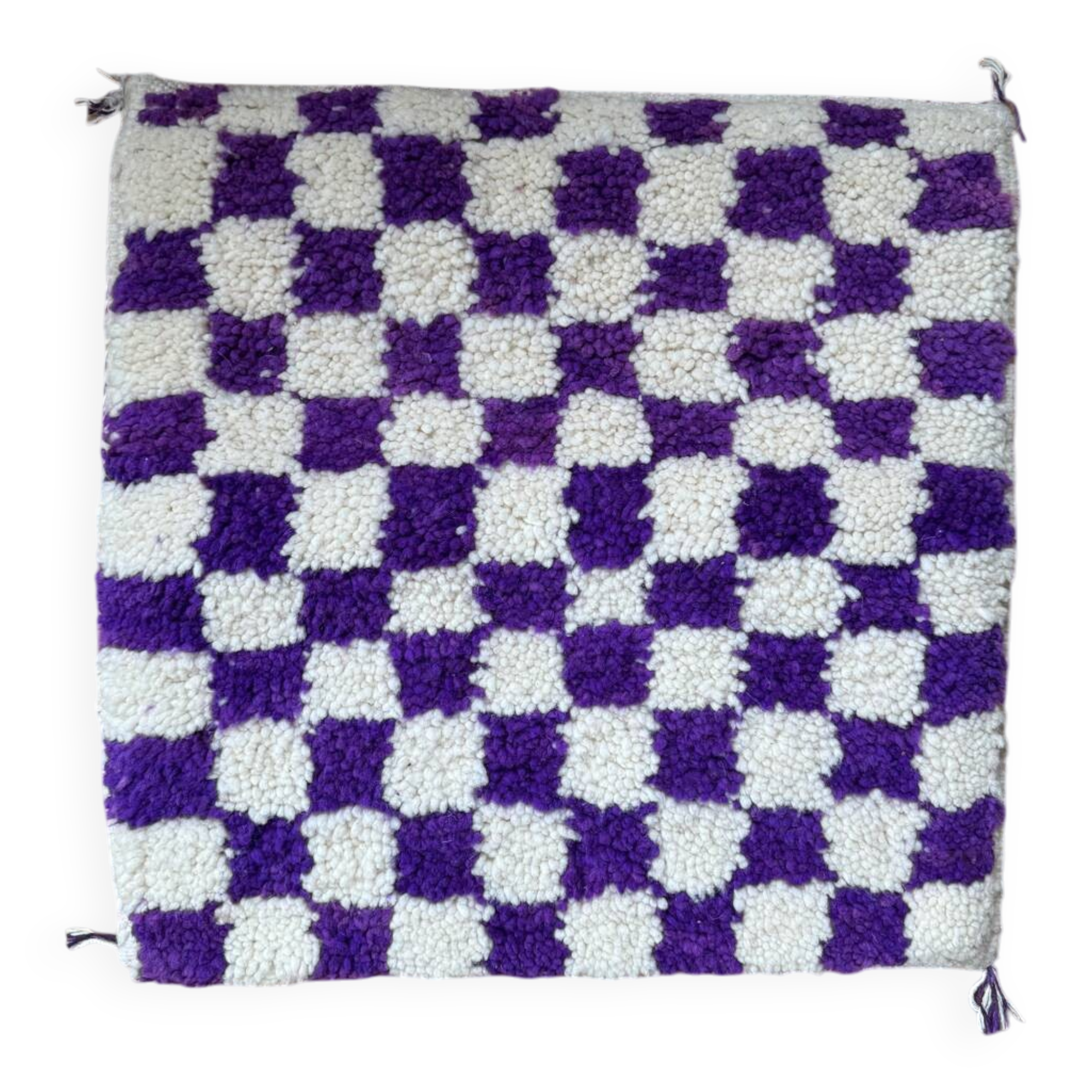 Square cushion cover with a checkered pattern.