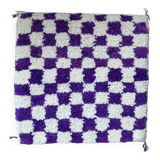 Square cushion cover with a checkered pattern.