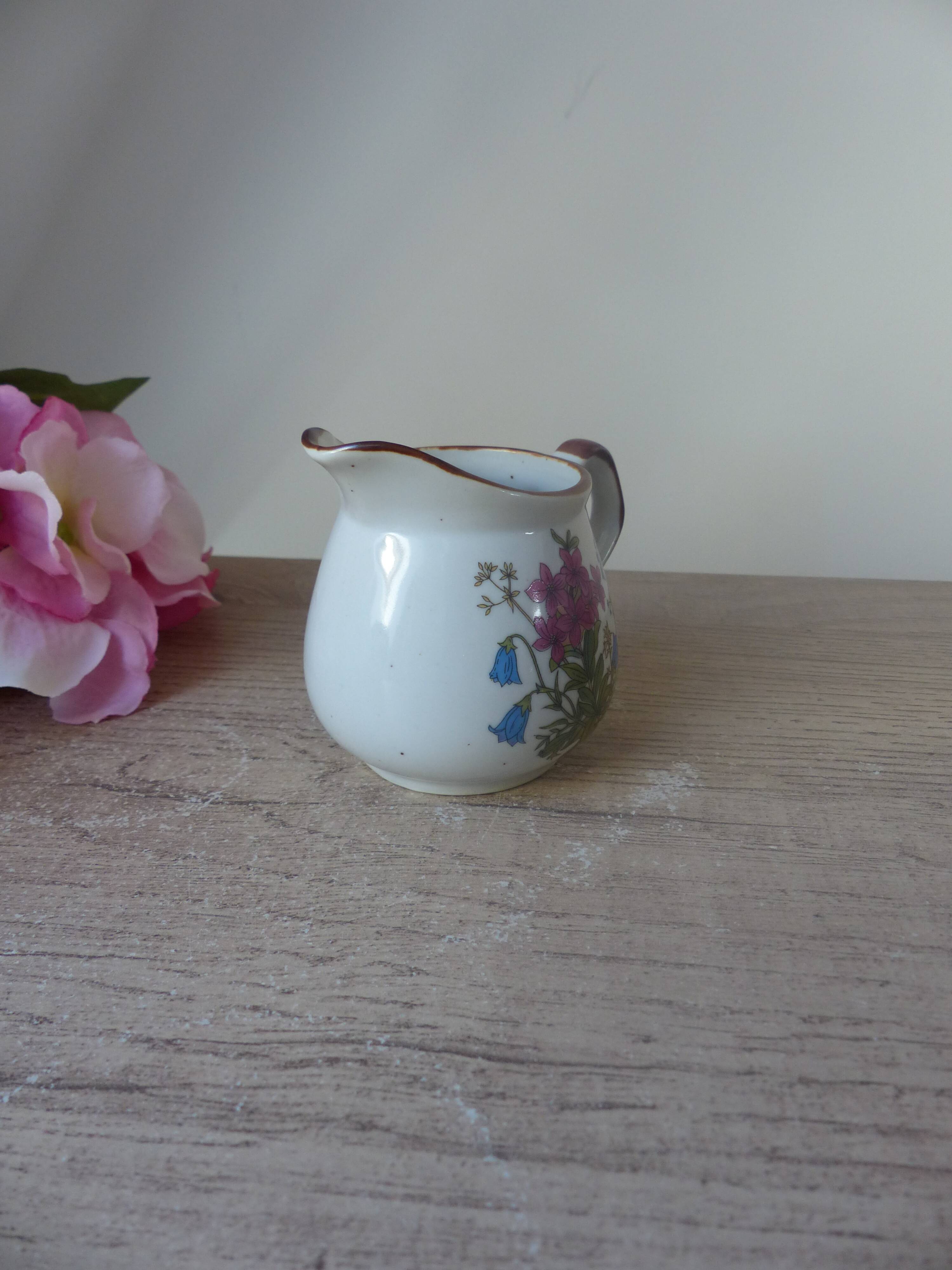 Old small artisanal milk jug in flowered speckled stoneware from the 1980s