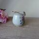 Vintage handmade speckled stoneware milk jug with floral design from the 1980s.