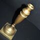 Antique baluster candlestick in bronze with hand-chiseled design.