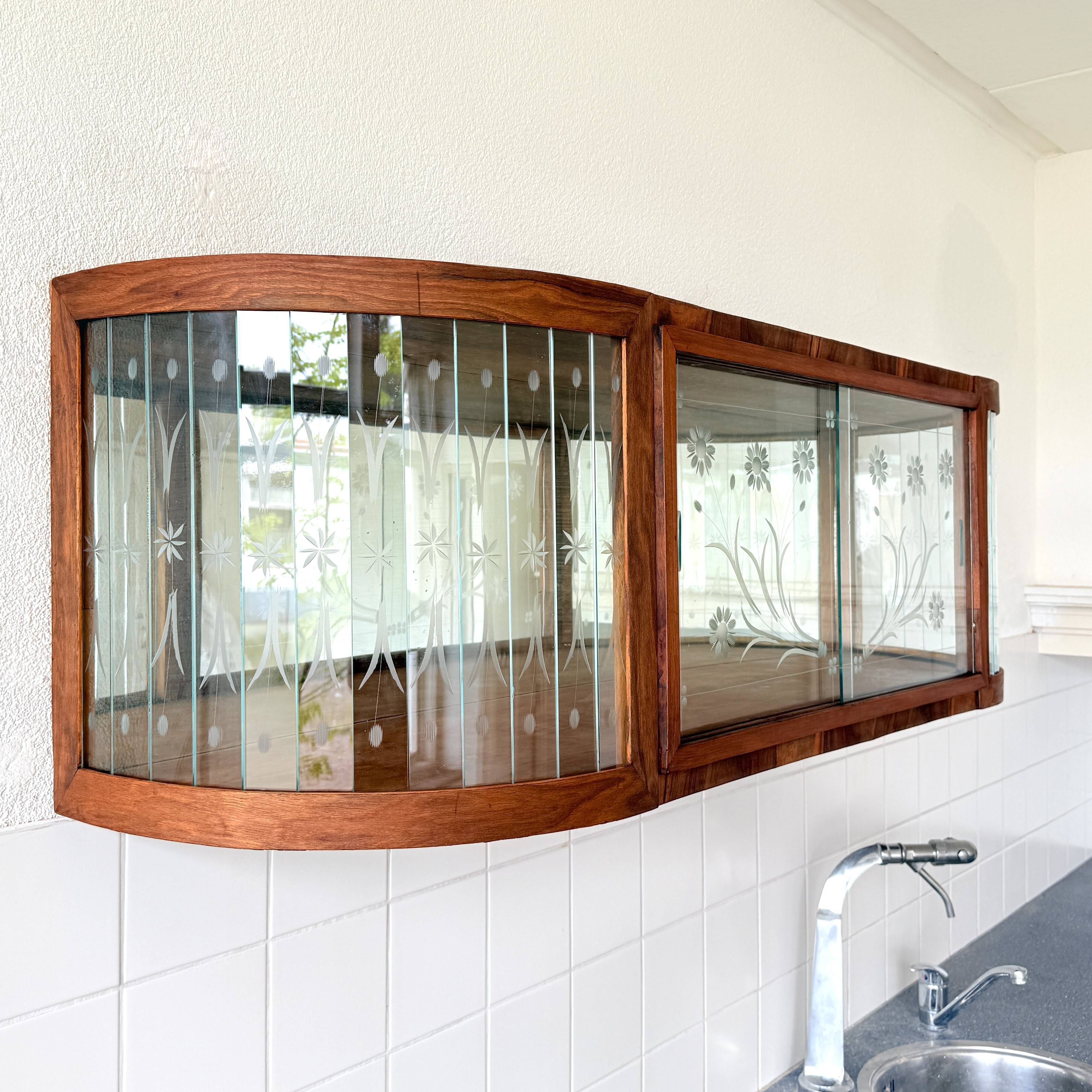 Art Deco-style wall-mounted display cabinet with floral engraving