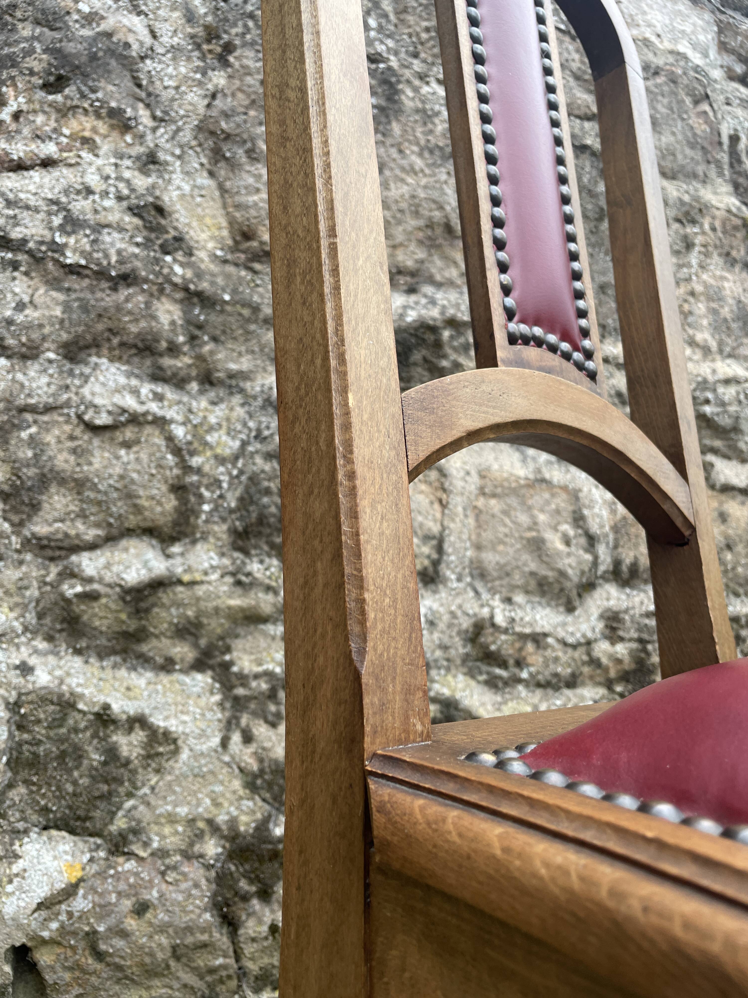 Pair of studded burgundy leather Art Deco chairs