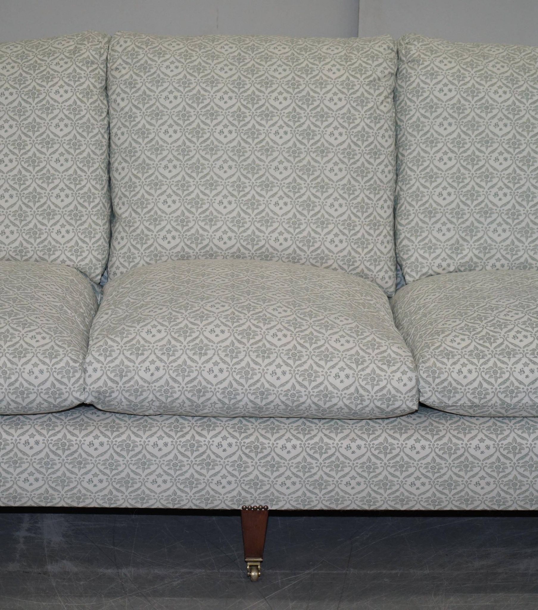 Howard & Sons canapé with feather cushions and ticking fabric, Victorian style.