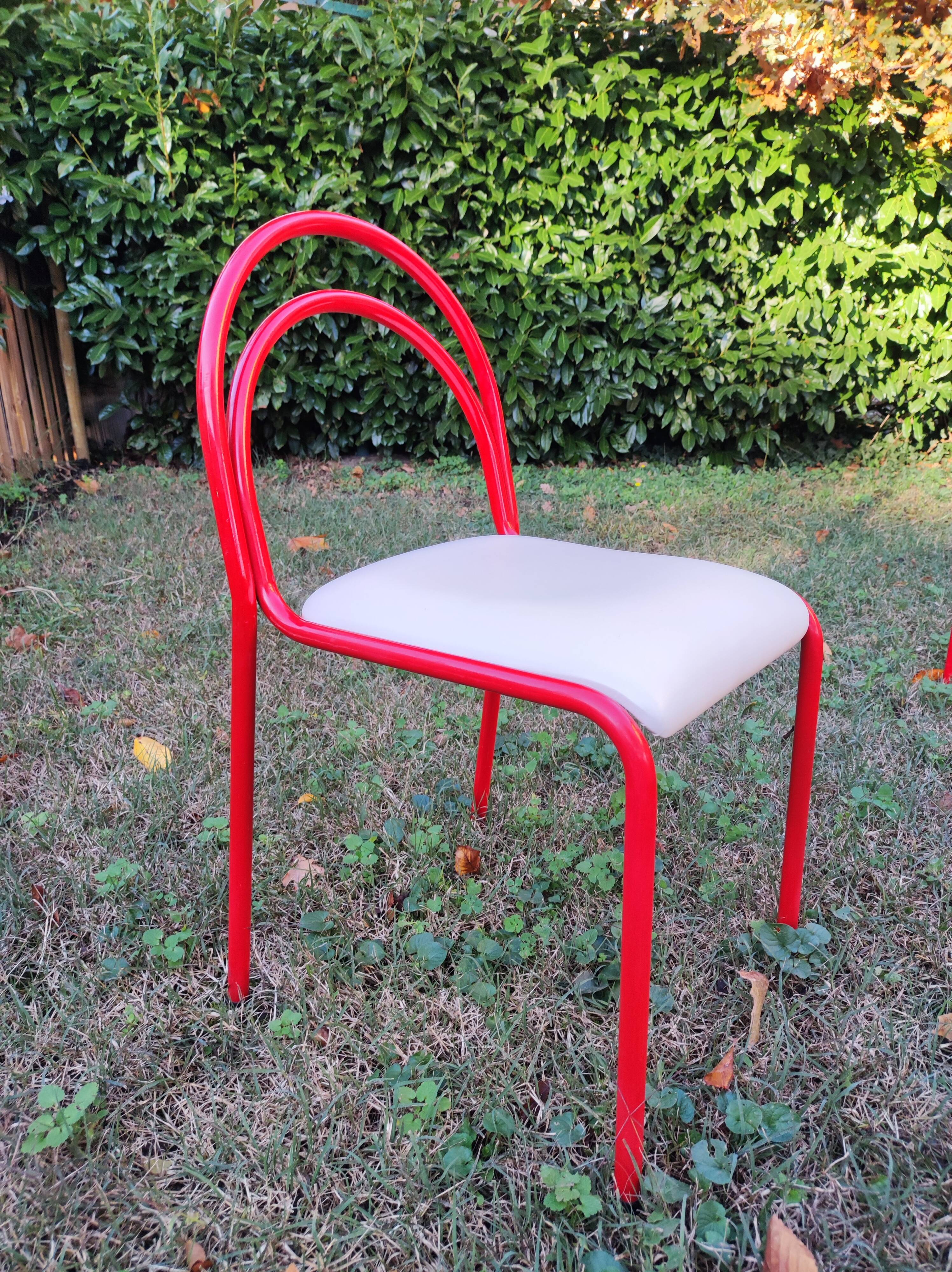 Stackable chairs, Italy, 1980s, red metal, white vinyl