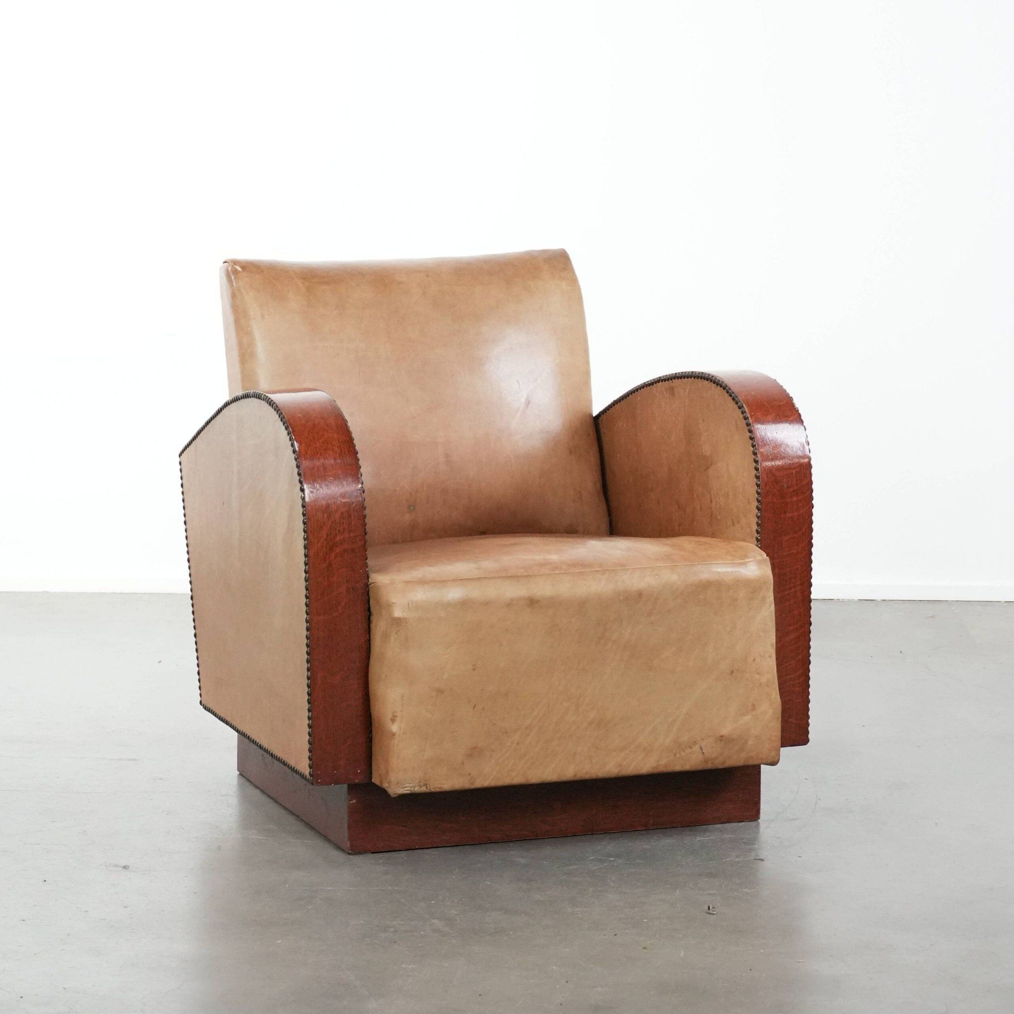 Art Deco design armchair in light cognac cowhide leather.
