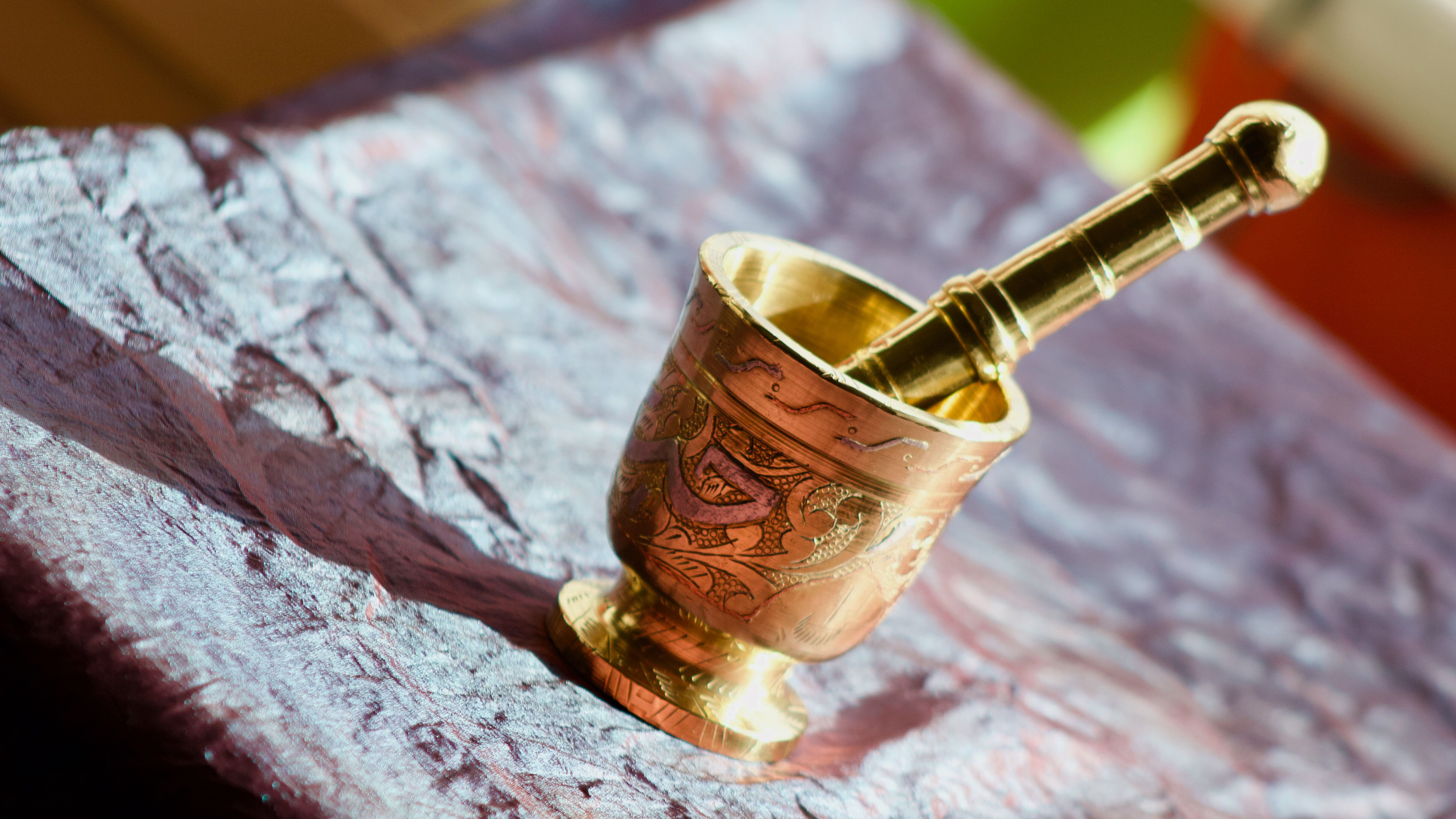 Mortar and its brass pestle with oriental gold and silver motifs