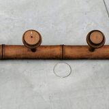 Old rustic wooden coat rack turned in imitation of bamboo