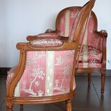 Pair of Louis XVI style armchairs in walnut and pink silk and ecru
