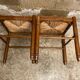 Pair of vintage wooden stools with woven straw seats
