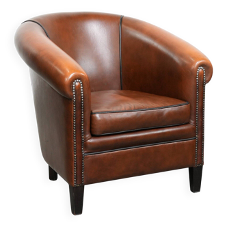 Beautiful and comfortable club armchair in English style made of cowhide leather