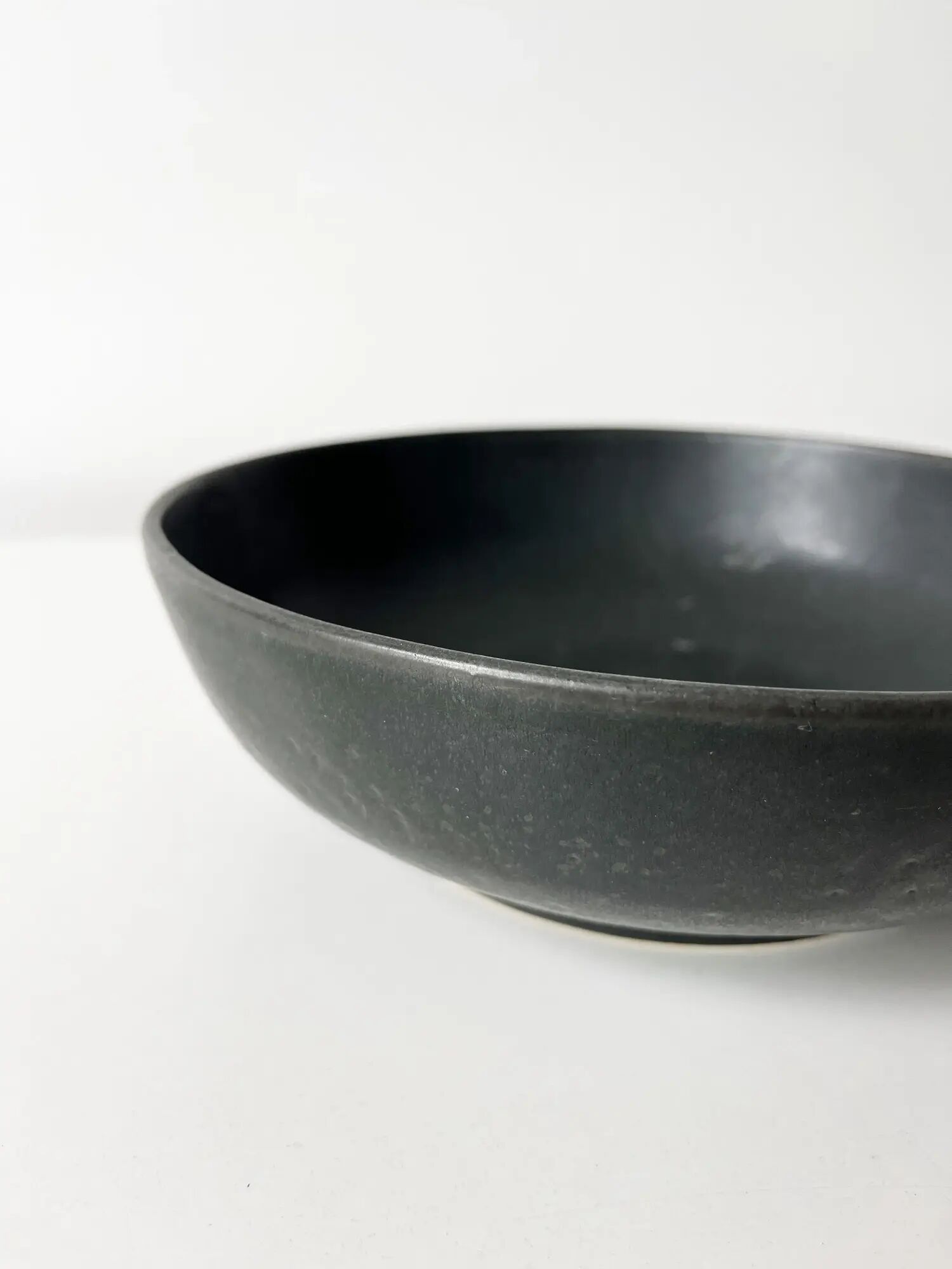 Round vintage black ceramic catchall.
