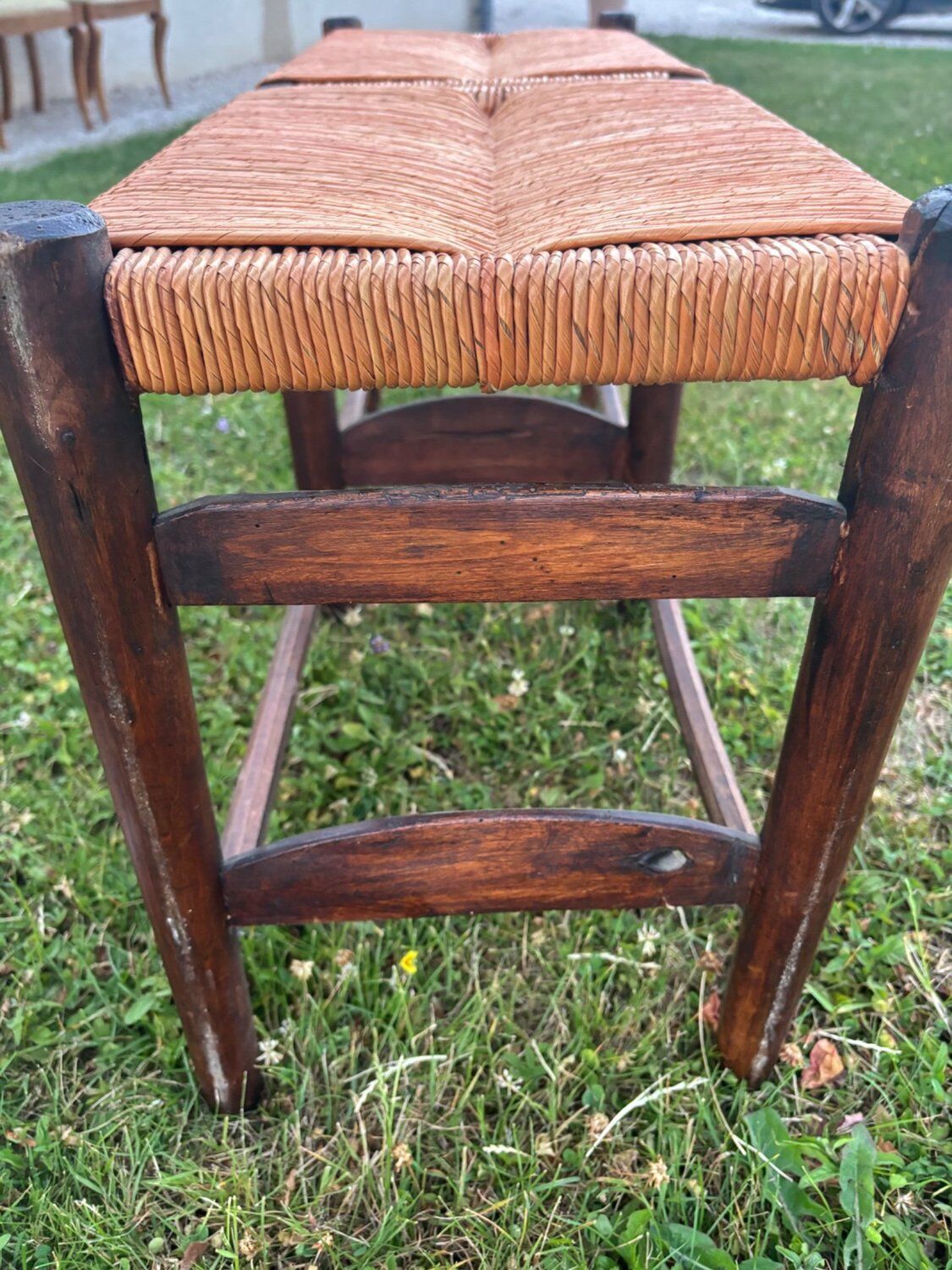 Two-seater straw bench, French rural style, wood and rush, early 20th century.