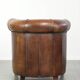 Sheepskin clubarmchair with beautiful patina finished with decorative nails