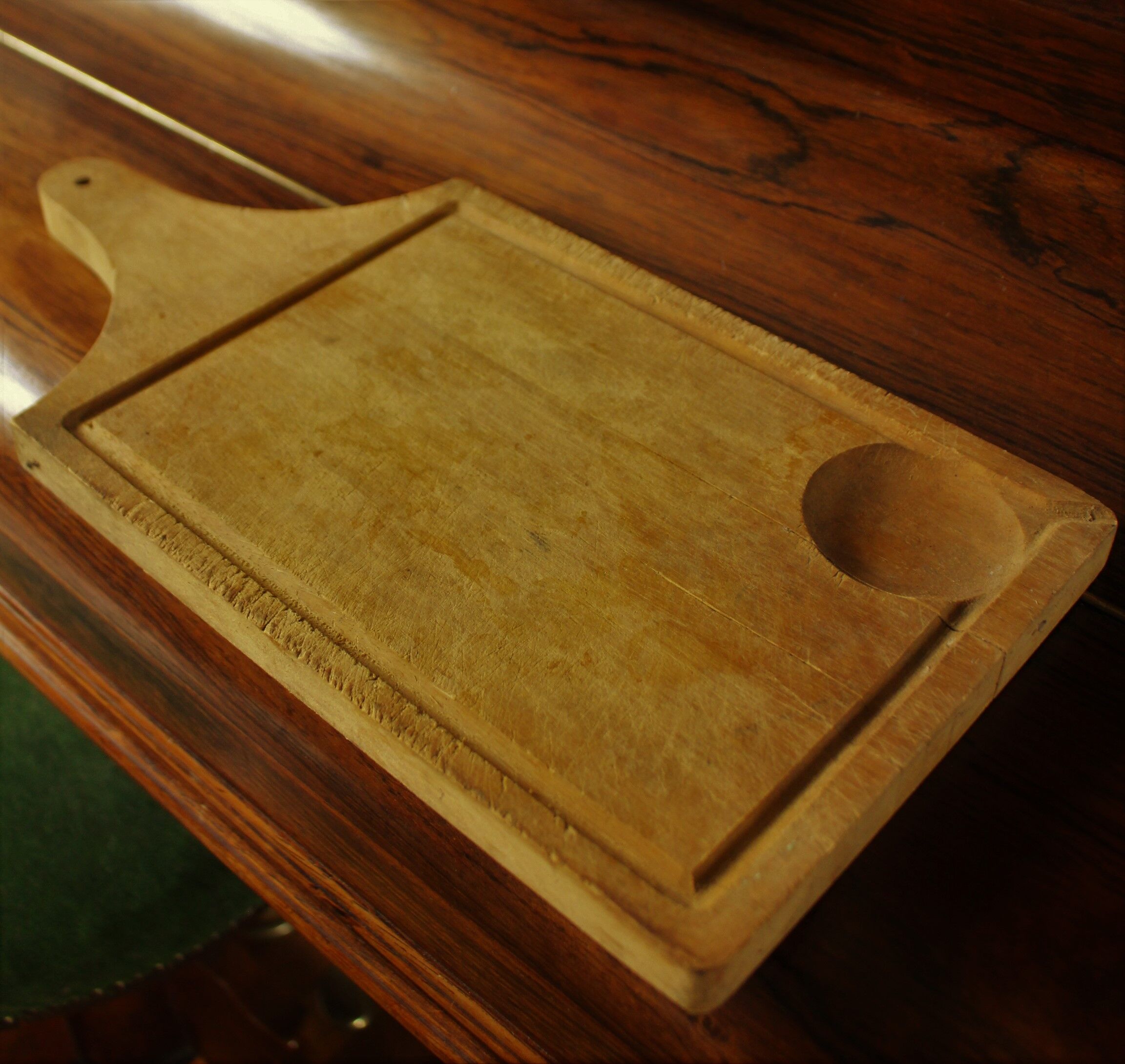 Wood cutting board with groove and handle