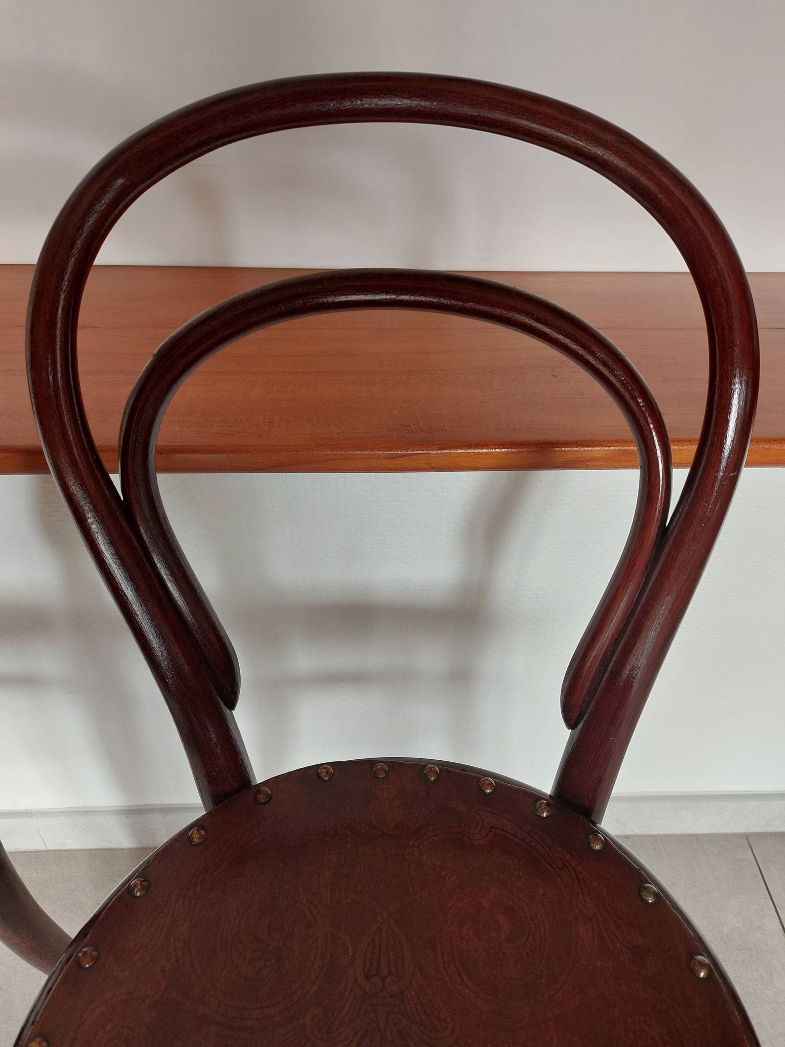 pair of round bistro chairs with a pattern on the seat, vintage