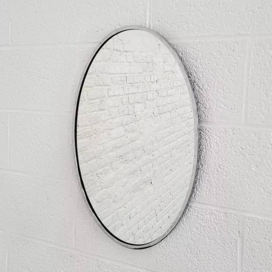 Oval mirror from the 1960s with a chrome frame.