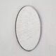 Oval mirror from the 1960s with a chrome frame.