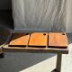 Small rectangular teak monoxyle cutting board with a circular handle.