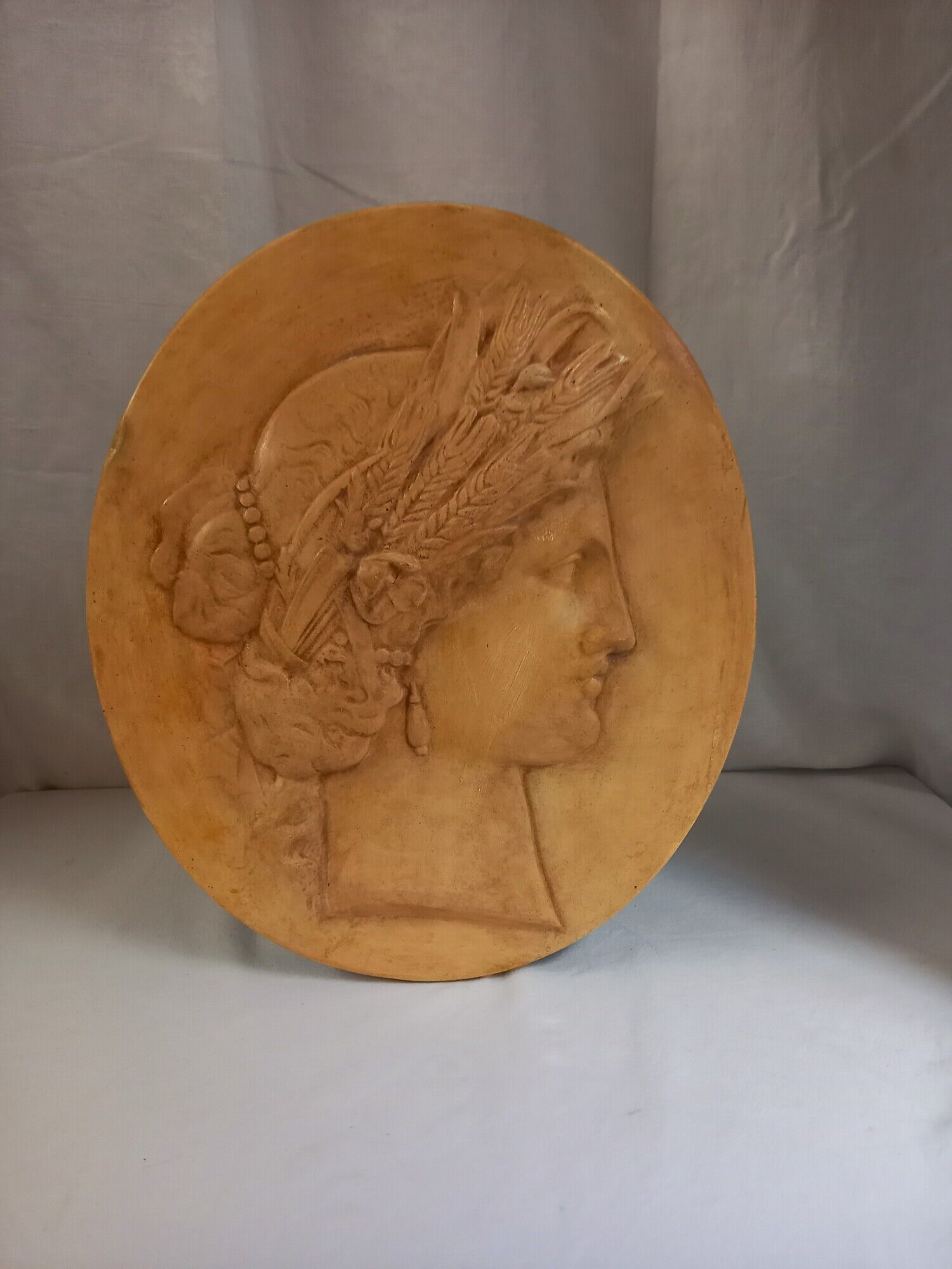Plaster medallion, high relief, yellow ochre patina, representing the Roman divinity Ceres