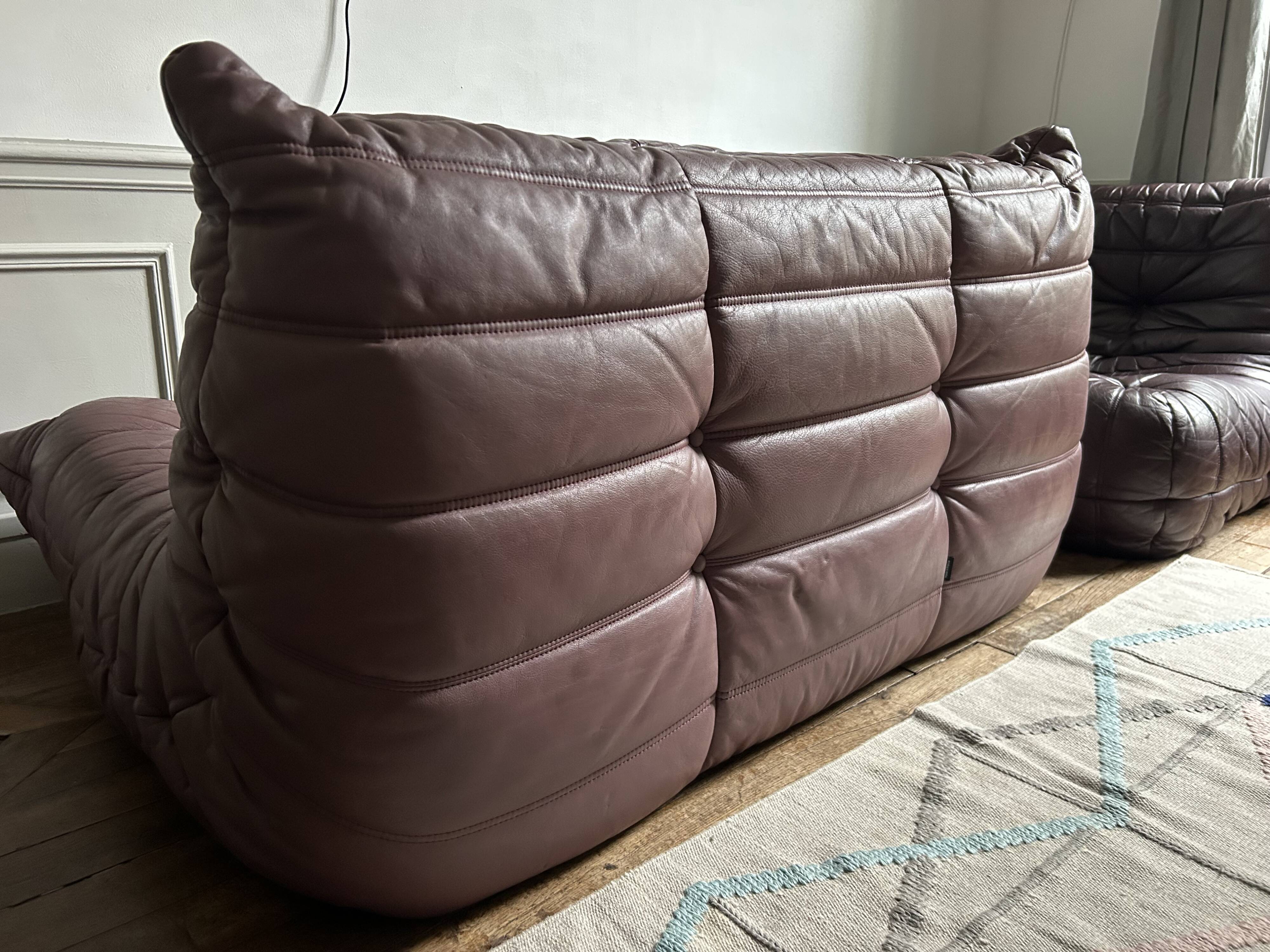Togo set by Ligne Roset in vintage pink, plum, and burgundy leather.