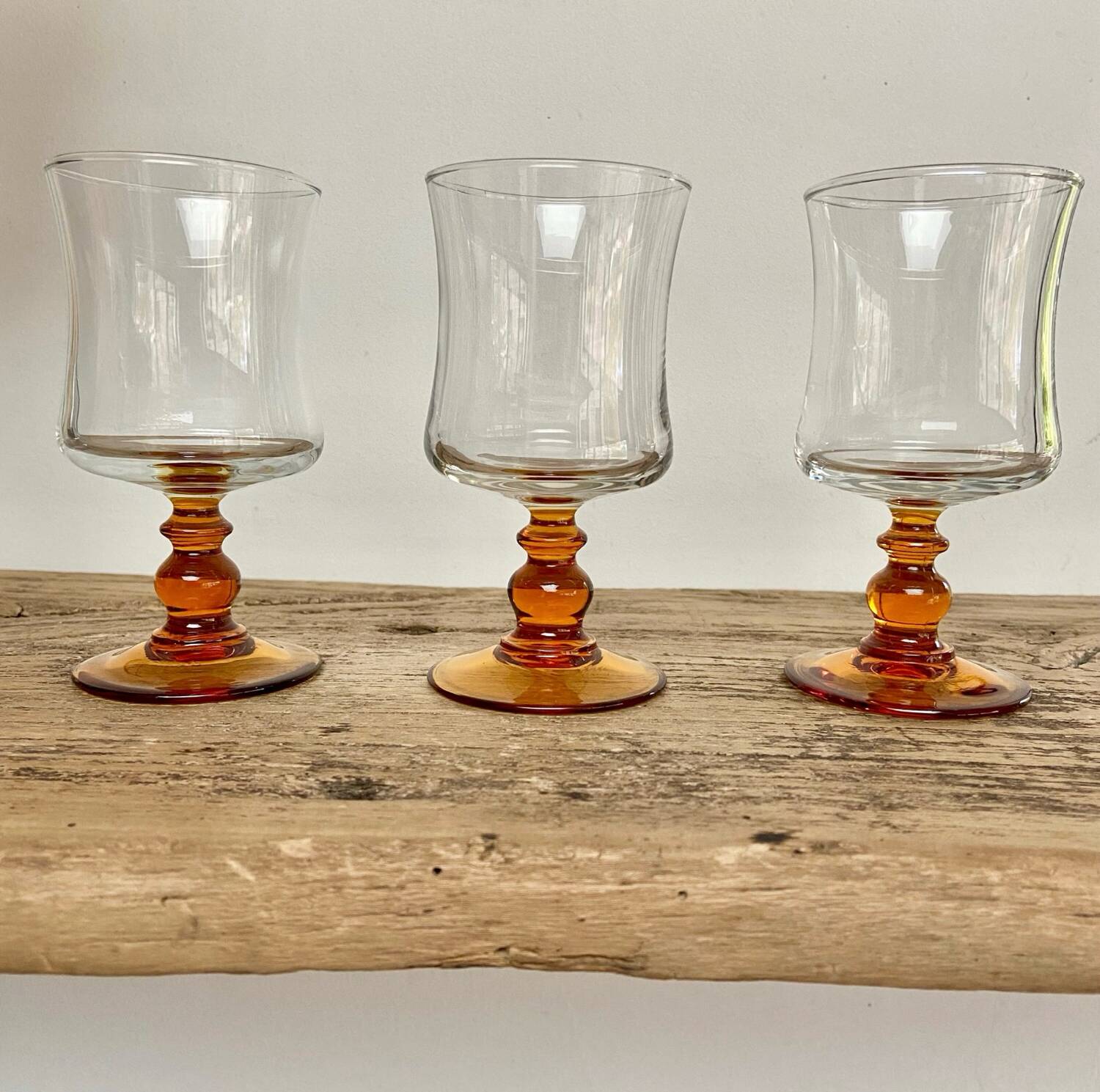 6 small amber stemmed glasses