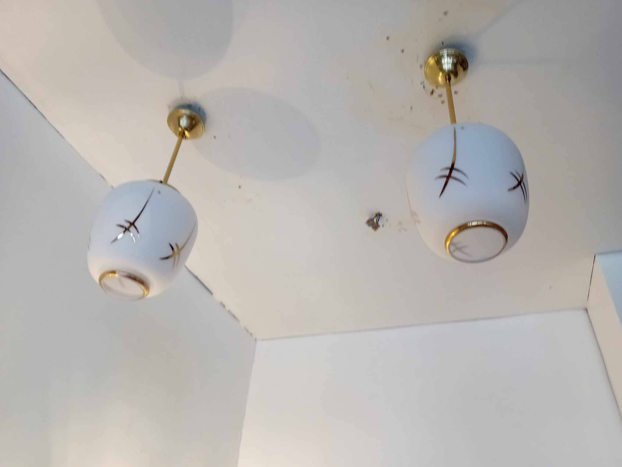 Pair of opaline globe pendant lights with stylized decoration, 1950s