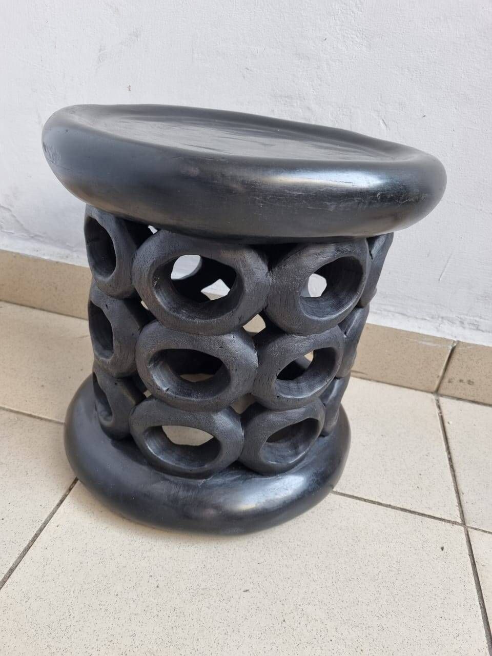 Bamiléké black stool in carved wood with rings – 33 × 35 cm