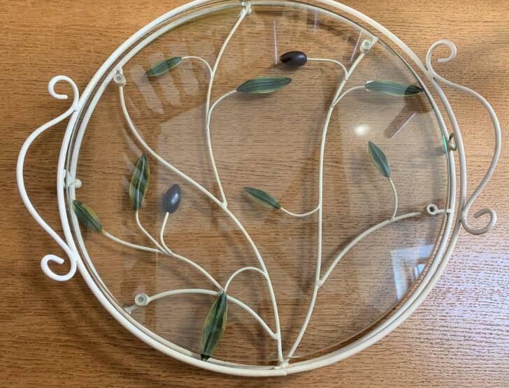 Round wrought iron and glass tray decorated with olives and foliage
