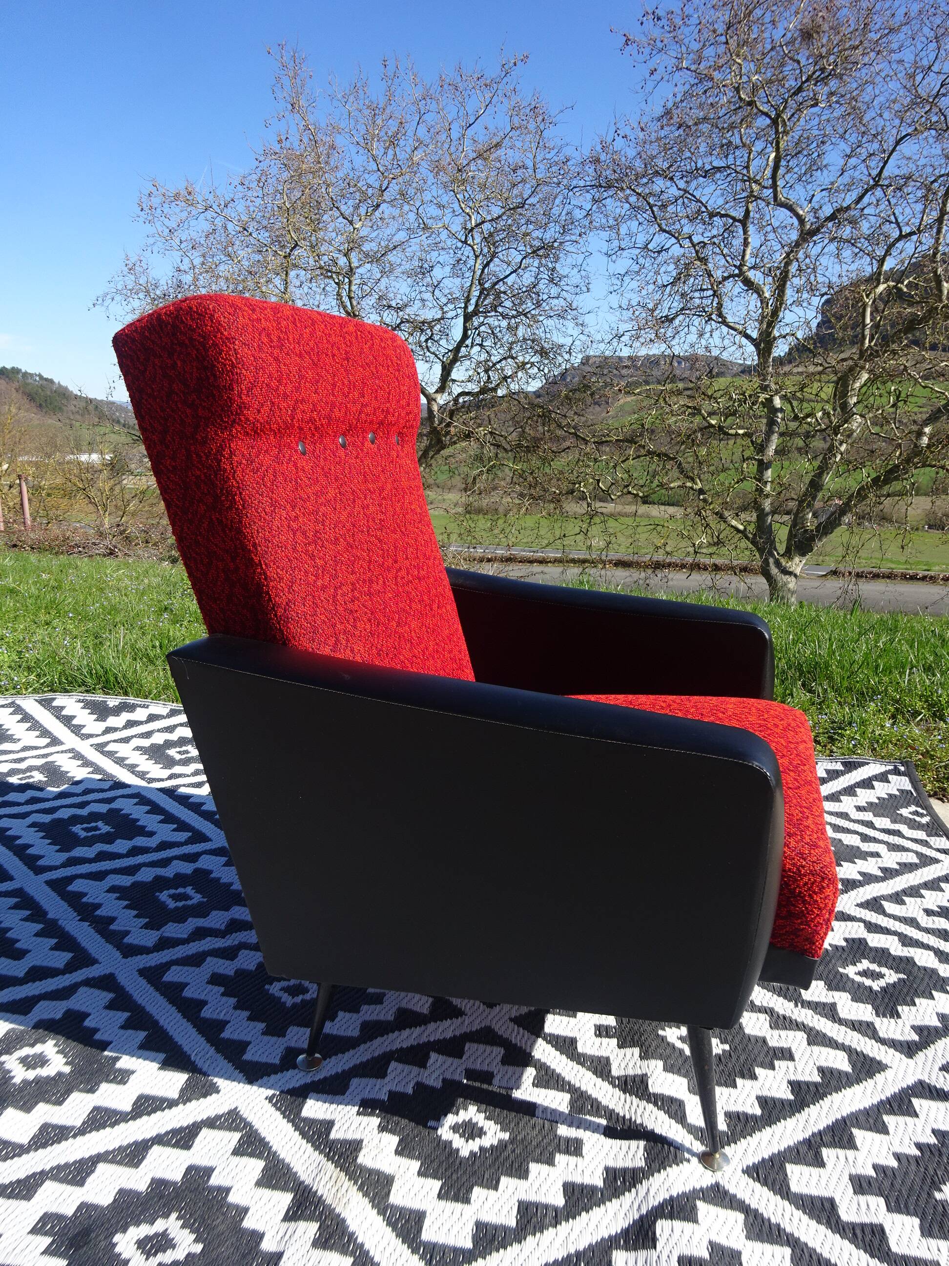 Vintage armchairs in red and black faux leather, the pair.
